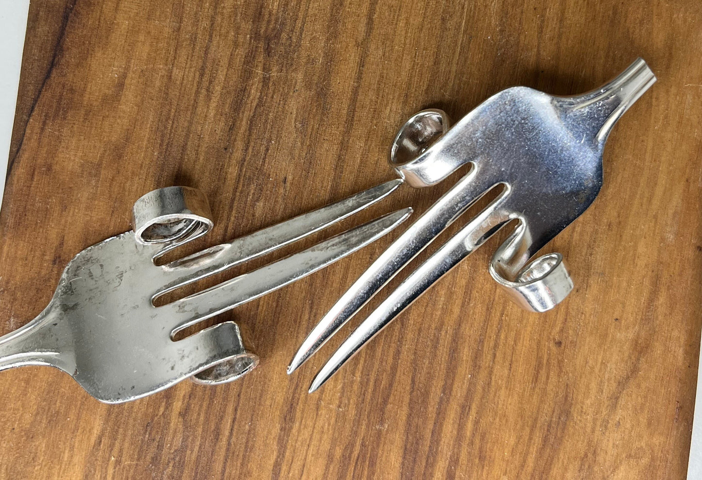 Silver plated fork corn holders.