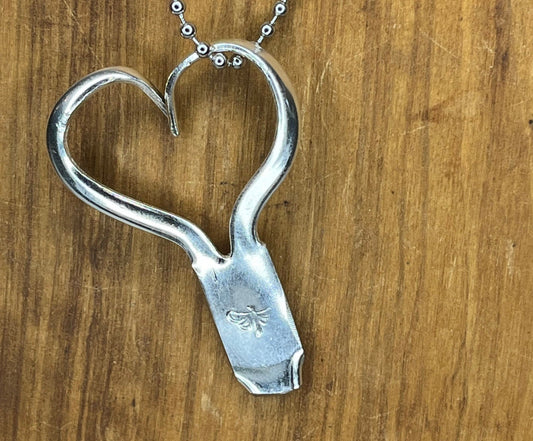 Silver Heart Shaped Necklace made from repurposed antique silverware fork tines with dragonfly hand stamped on the base.